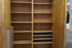 210 (view inside built-in wood cabinet on west wall to left of door)