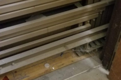 Looking west at bleachers from door in storage room across from phy ed office