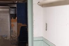 Under steps storage on south end of building - looking west