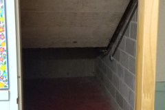 Under steps storage on south end of building - looking south