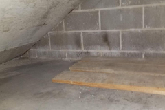 Under steps storage on south end of building - looking east