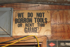 We do not borrow tools or rent this garage sign above office entrance