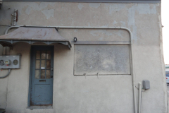 Looking west at entrance to attached building