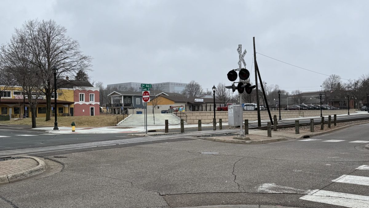 Looking southwest at Second Avenue and Lewis Street. Former lumber yard, now municipal parking lot (March 2025).